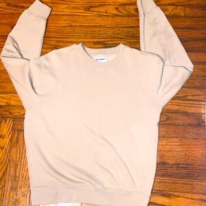 This medium light brown sweatshirt has a cozy and casual vibe. Lightly worn